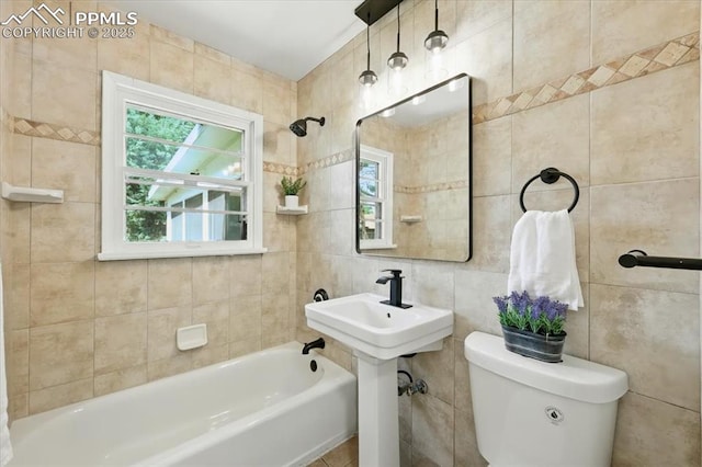 1314 Pioneer Rd, Colorado Springs, CO 80907 - bathroom with tile walls and shower / tub combination