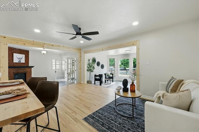 1314 Pioneer Rd, Colorado Springs, CO 80907 - living area with wood finished floors, recessed lighting, ceiling fan, a brick fireplace, and plenty of natural light