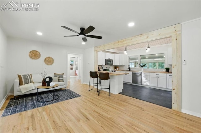 1314 Pioneer Rd, Colorado Springs, CO 80907 - living area with wood finished floors, recessed lighting, and ceiling fan