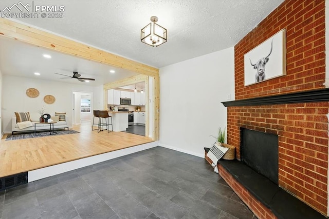 1314 Pioneer Rd, Colorado Springs, CO 80907 - unfurnished living room with a fireplace, ceiling fan, recessed lighting, and a textured ceiling