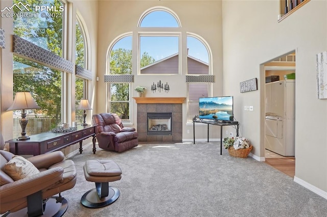 392 Pyrite Ter, Colorado Springs, CO 80905 - carpeted living area featuring a towering ceiling and a tile fireplace