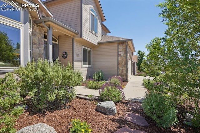 392 Pyrite Ter, Colorado Springs, CO 80905 - entrance to property featuring stone siding and a shingled roof