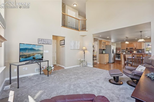 392 Pyrite Ter, Colorado Springs, CO 80905 - living area featuring light carpet, a towering ceiling, and recessed lighting