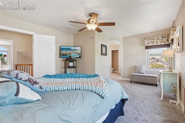 392 Pyrite Ter, Colorado Springs, CO 80905 - carpeted bedroom with arched walkways, multiple windows, and a ceiling fan