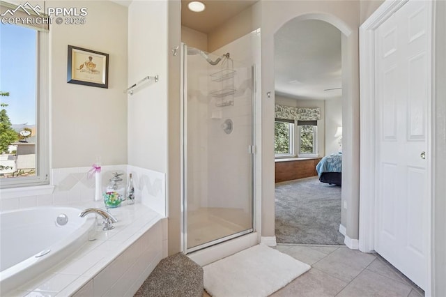 392 Pyrite Ter, Colorado Springs, CO 80905 - ensuite bathroom featuring a shower stall, a garden tub, and tile patterned floors