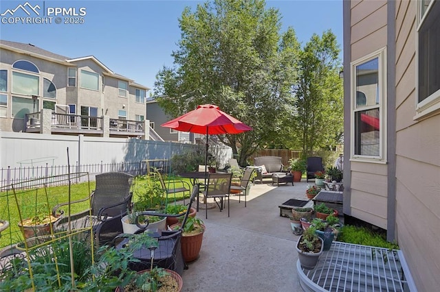 392 Pyrite Ter, Colorado Springs, CO 80905 - fenced backyard featuring a patio area, an outdoor hangout area, and outdoor dining space