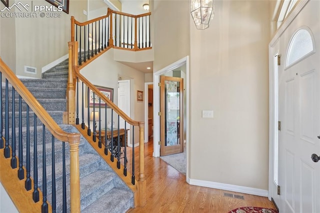 392 Pyrite Ter, Colorado Springs, CO 80905 - foyer entrance with wood finished floors, stairway, a towering ceiling, and a chandelier