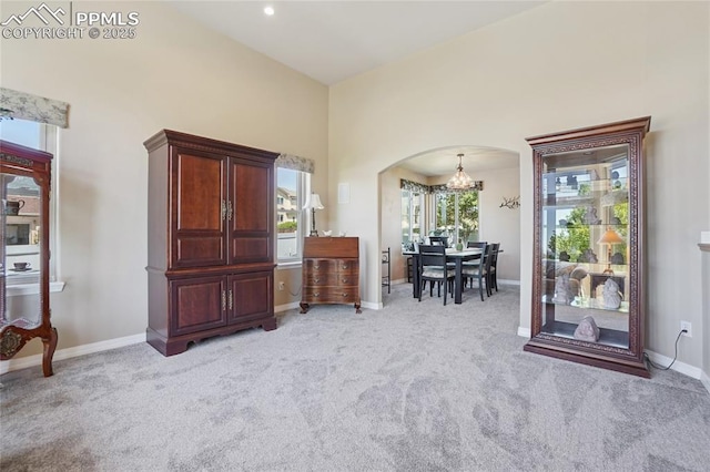 392 Pyrite Ter, Colorado Springs, CO 80905 - sitting room featuring arched walkways, a chandelier, and light carpet