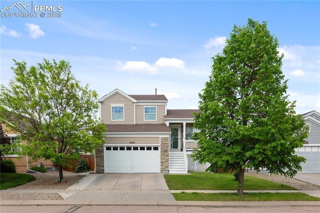 6355 Casual Dr, Colorado Springs, CO 80923 - tri-level home with concrete driveway, stone siding, an attached garage, and a front yard