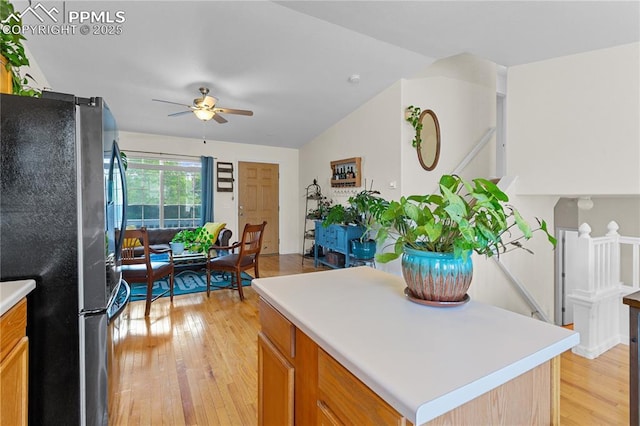 6355 Casual Dr, Colorado Springs, CO 80923 - kitchen featuring freestanding refrigerator, a ceiling fan, light wood-type flooring, light countertops, and vaulted ceiling