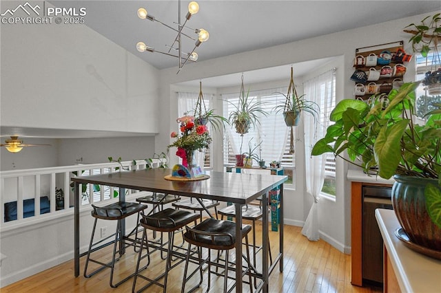 6355 Casual Dr, Colorado Springs, CO 80923 - dining space with light wood-type flooring, ceiling fan, a chandelier, and lofted ceiling