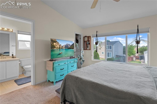 6355 Casual Dr, Colorado Springs, CO 80923 - bedroom with vaulted ceiling, ensuite bathroom, light colored carpet, and a ceiling fan