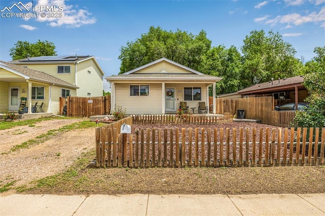1013 Maxwell St, Colorado Springs, CO 80906 - view of front of home with a porch, a fenced front yard, and a gate