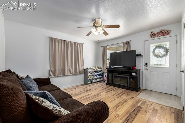 1013 Maxwell St, Colorado Springs, CO 80906 - living room featuring ceiling fan, wood finished floors, and a textured ceiling