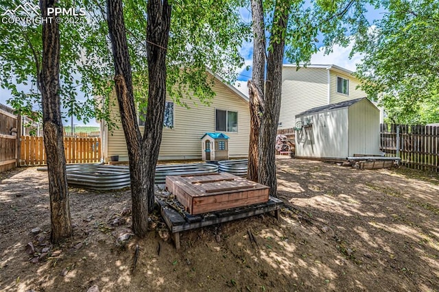 1013 Maxwell St, Colorado Springs, CO 80906 - rear view of house featuring a fenced backyard and a storage shed