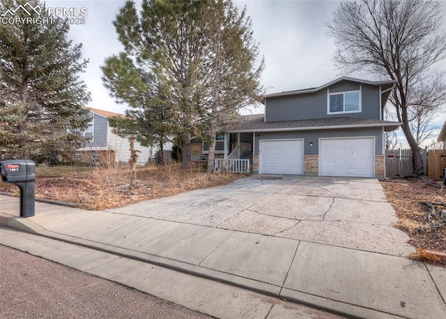 7465 Painted Rock Dr, Colorado Springs, CO 80911 - view of front facade featuring a garage, driveway, and covered porch