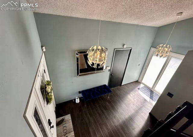 4110 Novia Dr, Colorado Springs, CO 80911 - foyer with a chandelier, a textured ceiling, lofted ceiling, and wood finished floors