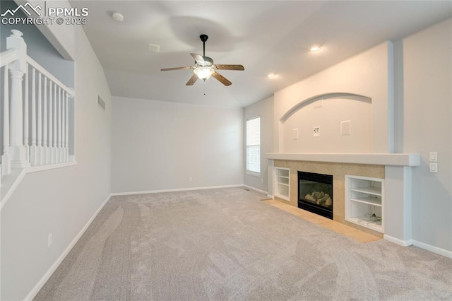 3355 Willowrun Dr, Castle Rock, CO 80109 - unfurnished living room featuring a ceiling fan, carpet floors, a tile fireplace, recessed lighting, and built in shelves