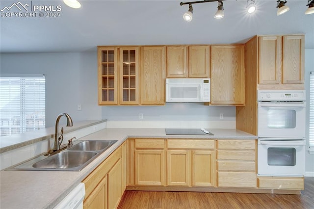 3355 Willowrun Dr, Castle Rock, CO 80109 - kitchen featuring white appliances, light brown cabinets, light wood-style flooring, and glass insert cabinets