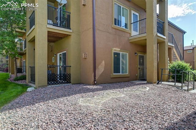 4888 Kerry Lynn Way Unit 101, Colorado Springs, CO 80922 - back of property with stucco siding and a balcony