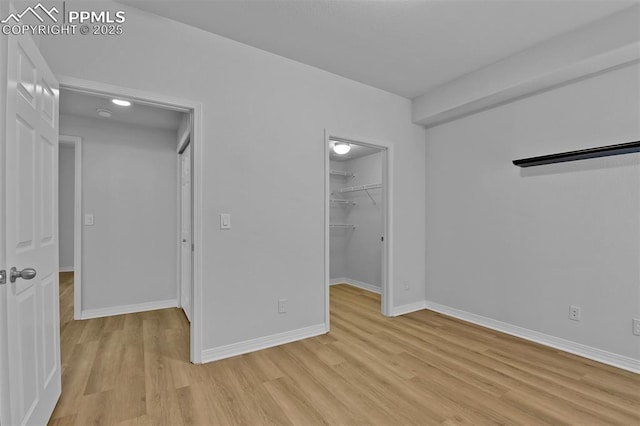 4888 Kerry Lynn Way Unit 101, Colorado Springs, CO 80922 - unfurnished bedroom with light wood-type flooring, a spacious closet, and a closet