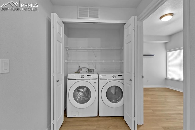 4888 Kerry Lynn Way Unit 101, Colorado Springs, CO 80922 - laundry room featuring washer and clothes dryer and light wood-style floors