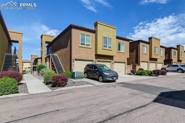 4888 Kerry Lynn Way Unit 101, Colorado Springs, CO 80922 - view of front of house featuring stairway, a garage, and a residential view