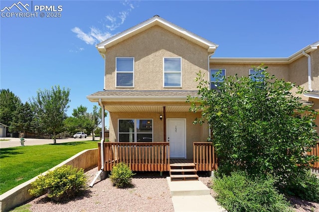 4400 Rawhide Rd Unit 157, Pueblo, CO 81008 - view of front of property with stucco siding, covered porch, and a front lawn