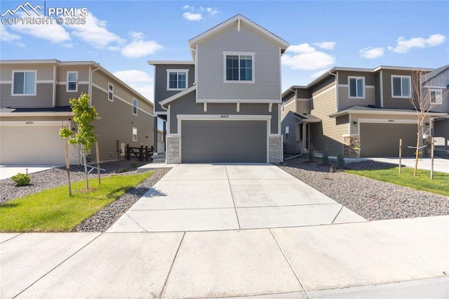 16423 Mountain Flax Dr, Monument, CO 80132 - view of front facade featuring an attached garage, stone siding, and concrete driveway