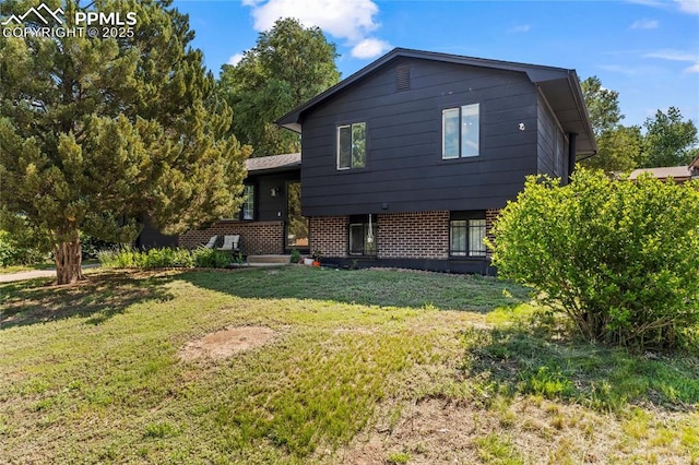 728 Squire St, Colorado Springs, CO 80911 - split level home with a front lawn and brick siding