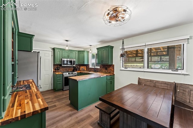 728 Squire St, Colorado Springs, CO 80911 - kitchen featuring stainless steel appliances, green cabinets, wooden counters, and backsplash