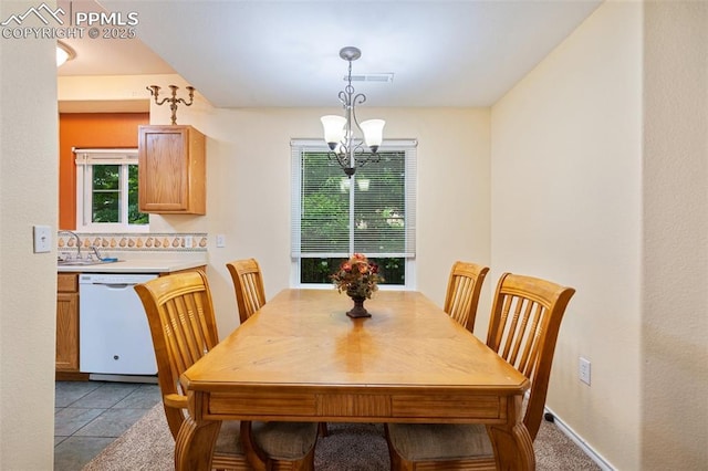 3847 Riviera Grv Unit 102, Colorado Springs, CO 80922 - dining room featuring a chandelier and light tile patterned floors