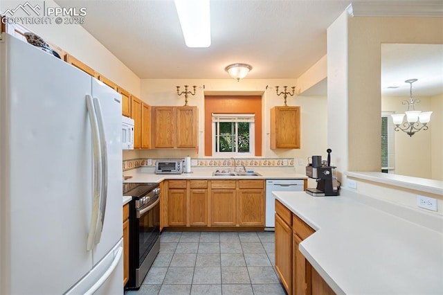 3847 Riviera Grv Unit 102, Colorado Springs, CO 80922 - kitchen with white appliances, light countertops, a chandelier, brown cabinetry, and pendant lighting