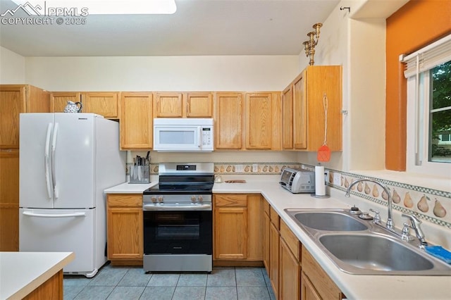 3847 Riviera Grv Unit 102, Colorado Springs, CO 80922 - kitchen featuring white appliances, light countertops, and light tile patterned floors