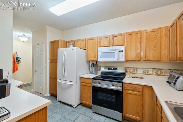 3847 Riviera Grv Unit 102, Colorado Springs, CO 80922 - kitchen featuring white appliances, light countertops, and light tile patterned flooring