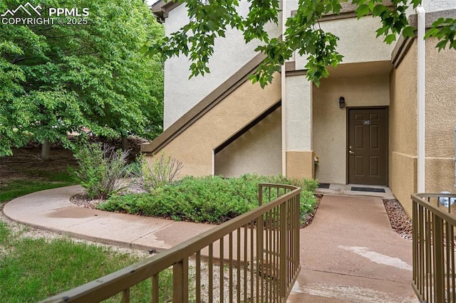 3847 Riviera Grv Unit 102, Colorado Springs, CO 80922 - doorway to property with stucco siding