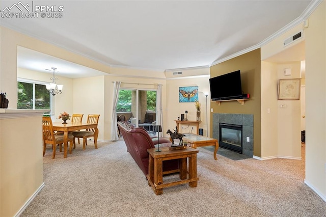 3847 Riviera Grv Unit 102, Colorado Springs, CO 80922 - living room featuring carpet flooring, crown molding, a tiled fireplace, and a chandelier