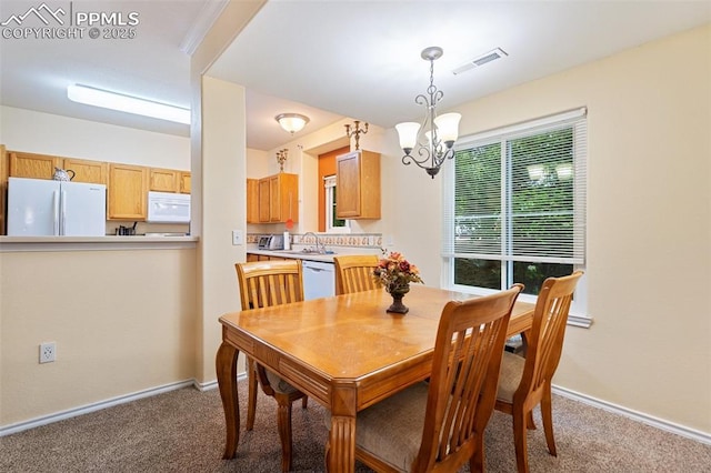 3847 Riviera Grv Unit 102, Colorado Springs, CO 80922 - dining room featuring a chandelier and carpet floors