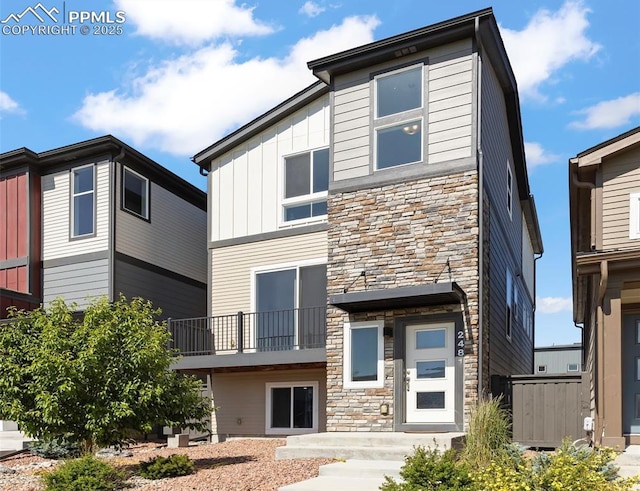 2481 Horsemanship Ct, Colorado Springs, CO 80922 - view of front of property with stone siding, board and batten siding, and a balcony