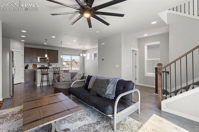 2481 Horsemanship Ct, Colorado Springs, CO 80922 - living area with a ceiling fan, dark wood-type flooring, recessed lighting, stairs, and a chandelier
