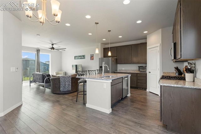 2481 Horsemanship Ct, Colorado Springs, CO 80922 - kitchen with stainless steel appliances, open floor plan, ceiling fan, dark wood-style floors, and recessed lighting