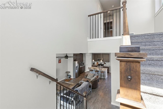 2481 Horsemanship Ct, Colorado Springs, CO 80922 - stairs with a towering ceiling, wood finished floors, and ceiling fan