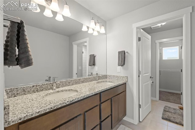 2481 Horsemanship Ct, Colorado Springs, CO 80922 - full bath with double vanity, tile patterned floors, and a walk in closet