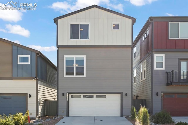 2481 Horsemanship Ct, Colorado Springs, CO 80922 - view of front of home featuring an attached garage, board and batten siding, and driveway