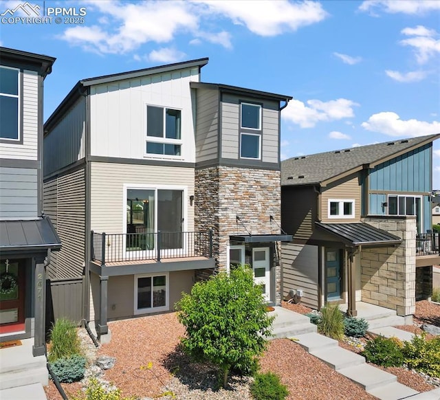 2481 Horsemanship Ct, Colorado Springs, CO 80922 - view of front of home featuring stone siding, board and batten siding, and a balcony