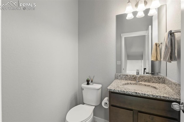 2481 Horsemanship Ct, Colorado Springs, CO 80922 - half bathroom featuring vanity and a textured wall
