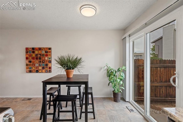 1275 Soaring Eagle Dr, Colorado Springs, CO 80915 - dining space featuring a textured ceiling and baseboards