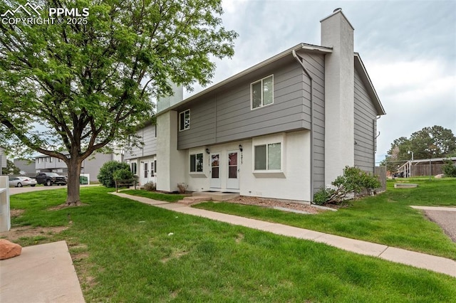1275 Soaring Eagle Dr, Colorado Springs, CO 80915 - view of front of home featuring a chimney and a front yard
