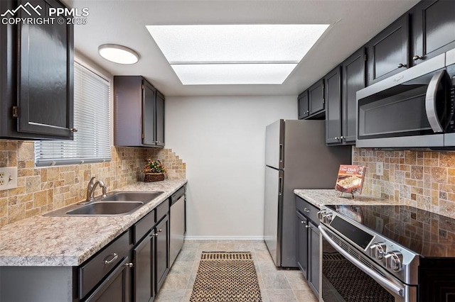 1275 Soaring Eagle Dr, Colorado Springs, CO 80915 - kitchen with appliances with stainless steel finishes, decorative backsplash, and light countertops