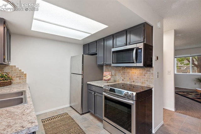 1275 Soaring Eagle Dr, Colorado Springs, CO 80915 - kitchen featuring appliances with stainless steel finishes, tasteful backsplash, and light countertops